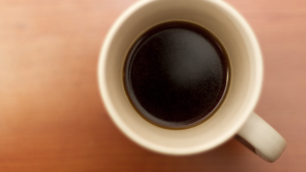 Small cup of black coffee on a table